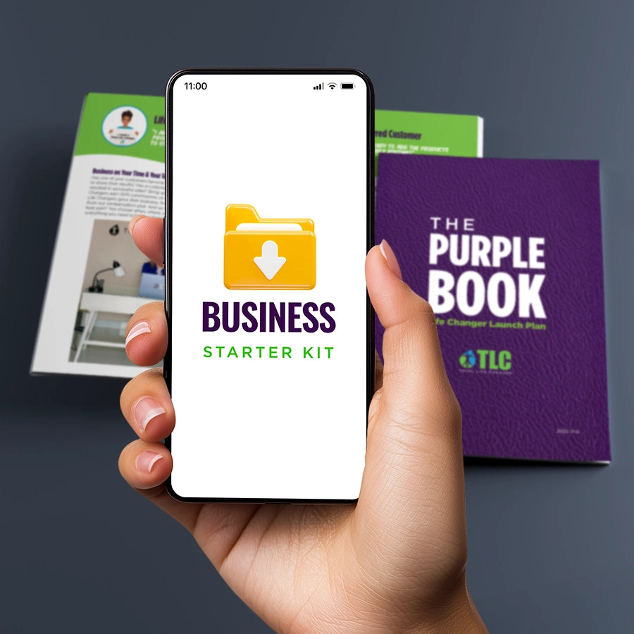 Hand holding a phone displaying 'Business Starter Kit' with TLC Purple Book in the background