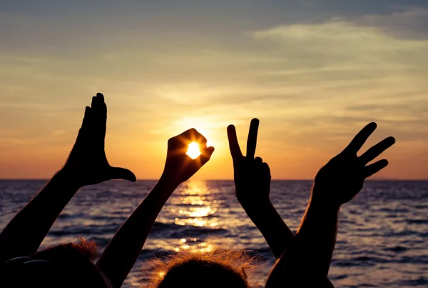 Love in Sign Language and an Ocean Sunset
