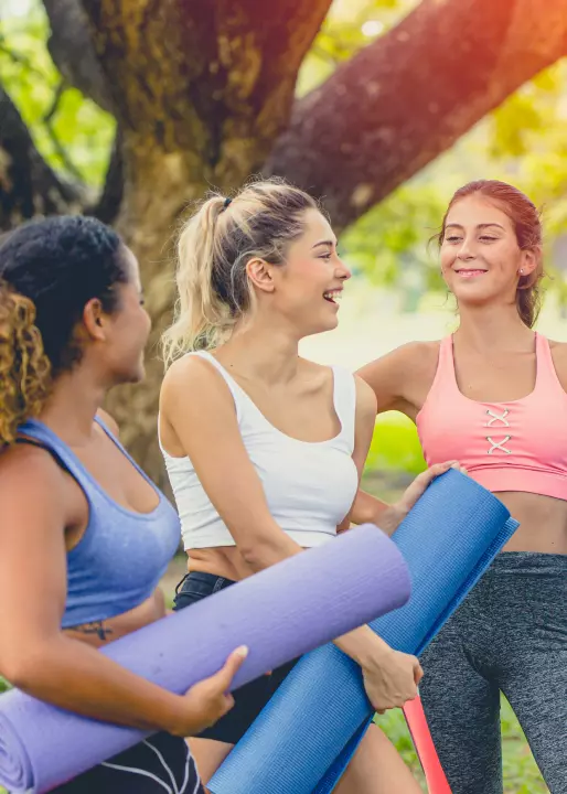 group of healthy girl with yoga mat enjoy talking together relax scene after finish yoga outdoor class