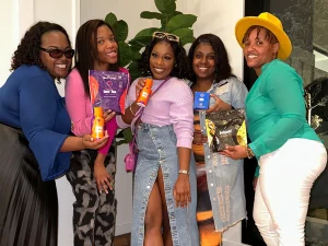 Women posing with TLC products